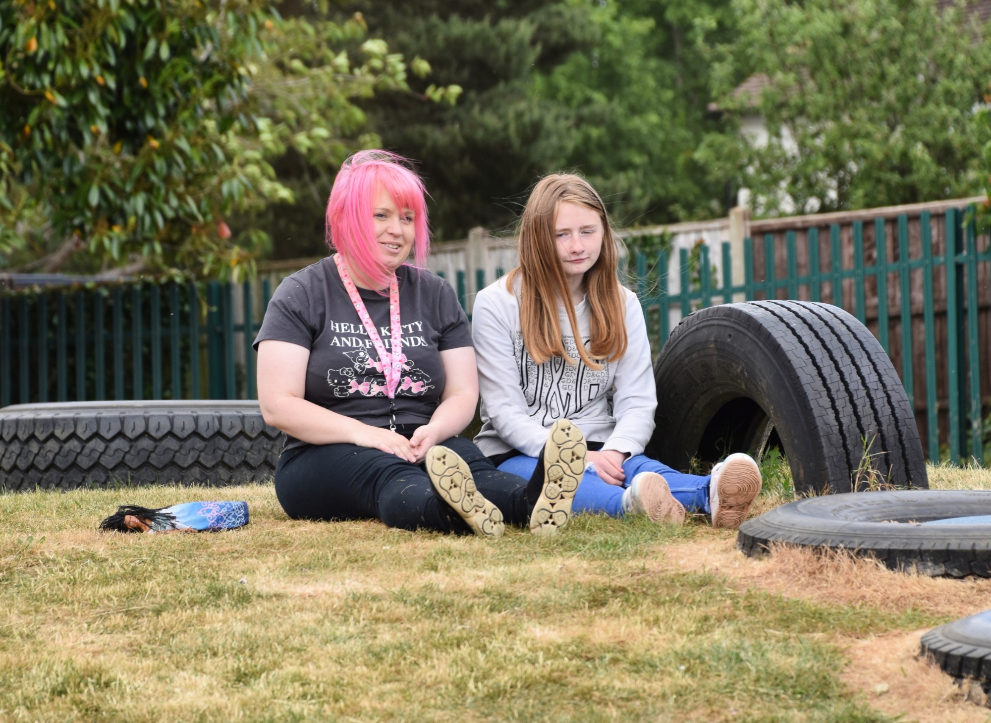Student and teaching assistant taking time out sitting on a hill at Wren Spinney